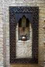 Fes-Morocco Old copper pot sits on a ledge with a carved wooden frame Art Print